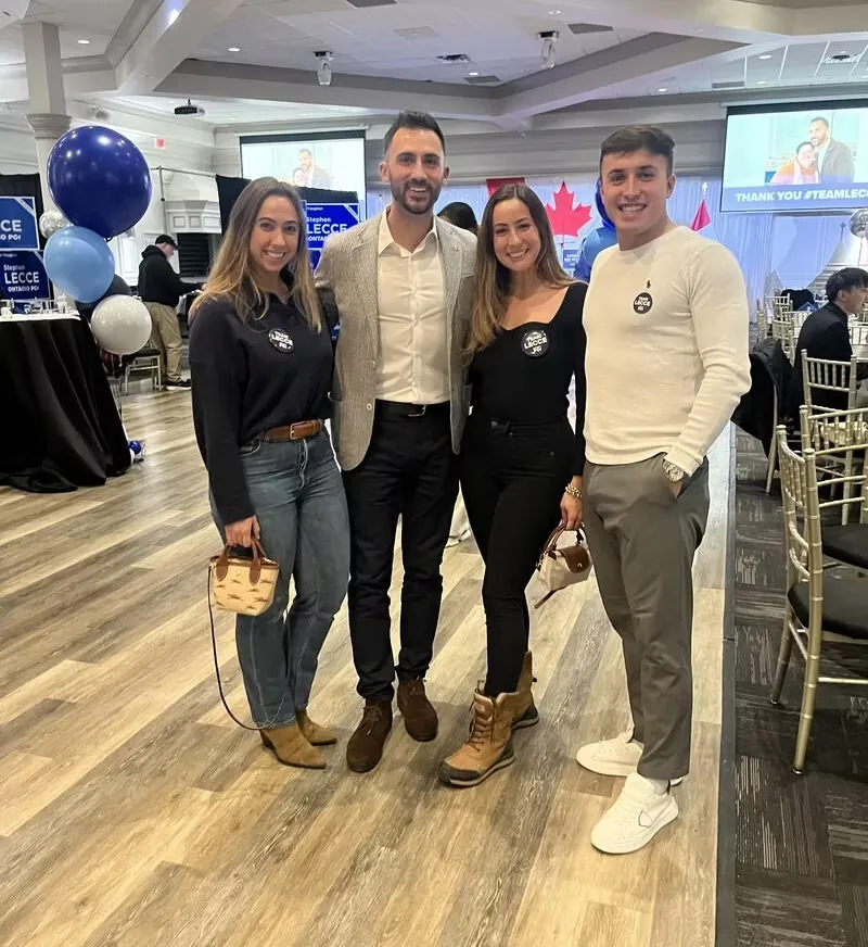 Four attendees posing together at a networking event